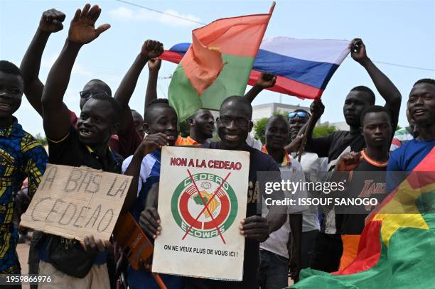 Small group of protesters hold Russian and Burkina Faso flags as they protest against the Economic Community of West African States , whose...