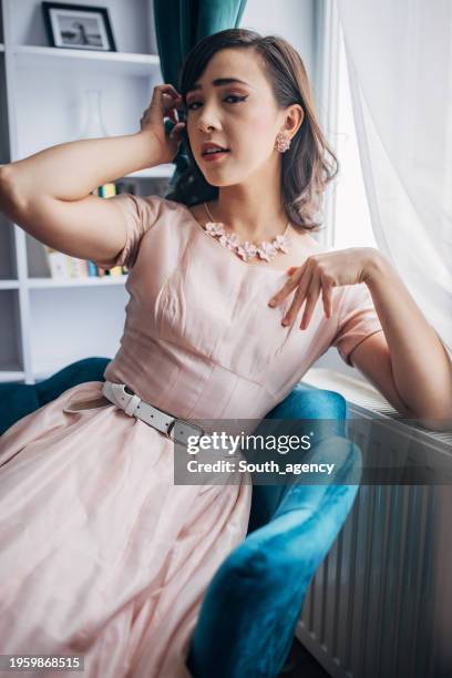 classy woman at home - pink dress stock pictures, royalty-free photos & images