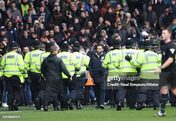 Carlos Corberan Manager of West Bromwich Albion walks away as police rush to sort problem with fans in ground during the Emirates FA Cup Fourth Round...