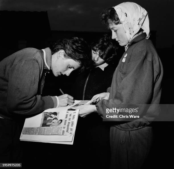 English sprinter Dorothy Hyman signing an autograph for a fan at her home track near Doncaster, September 1962. Hyman returned to training after...