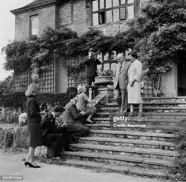 Sir Ralph Perring, 1st Baronet , the new Lord Mayor of London, and his wife Ethel being photographed by family members outside their home, Frensham...