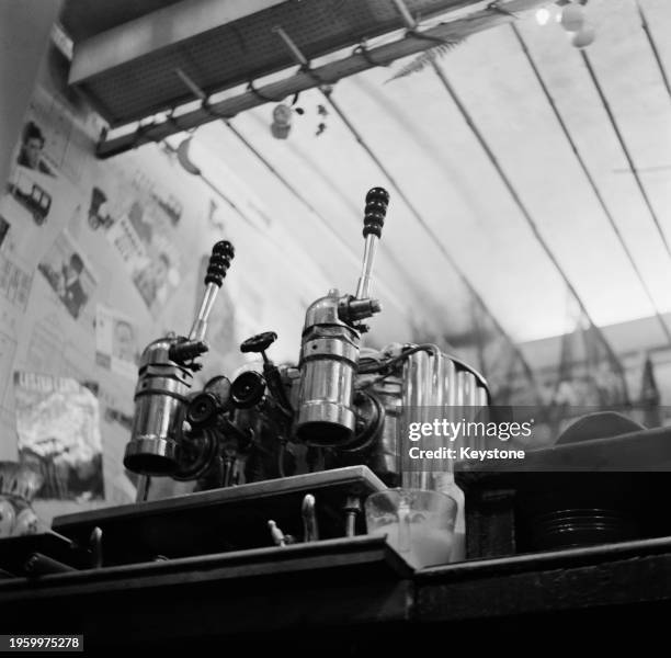 Low angle view of a Gaggia lever espresso machine at a coffee bar, October 1962.