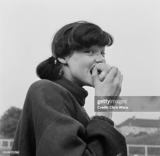 British athlete Linda Knowles, aged 16, biting into an apple in Hornchurch, Essex, October 1962.