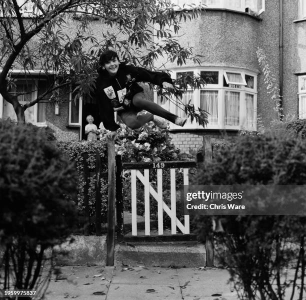 British athlete Linda Knowles, aged 16, jumping over a garden gate in Hornchurch, Essex, October 1962.