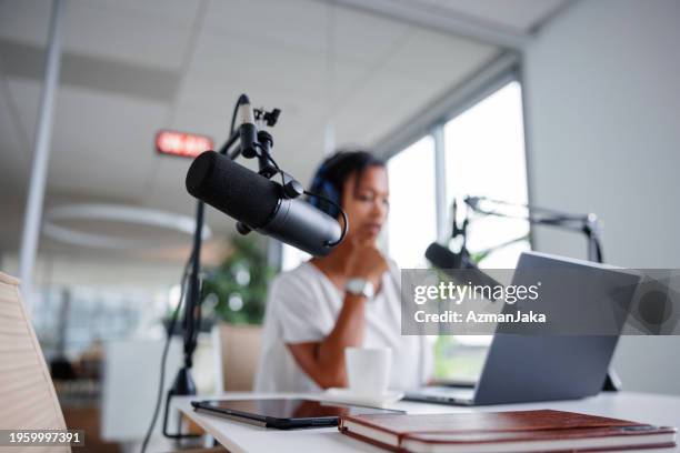 pre-broadcast setup by black female podcast host - content creation stock pictures, royalty-free photos & images