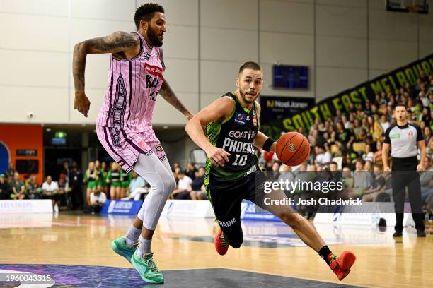 Ben Ayre of the Phoenix drives to the basket under pressure from Jonah Bolden of the Kings during the round 17 NBL match between South East Melbourne...