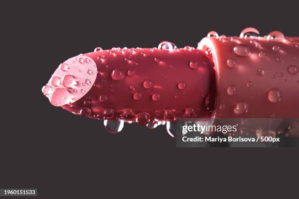 close-up of water splashing against black background - red lipstick stick stock pictures, royalty-free photos & images