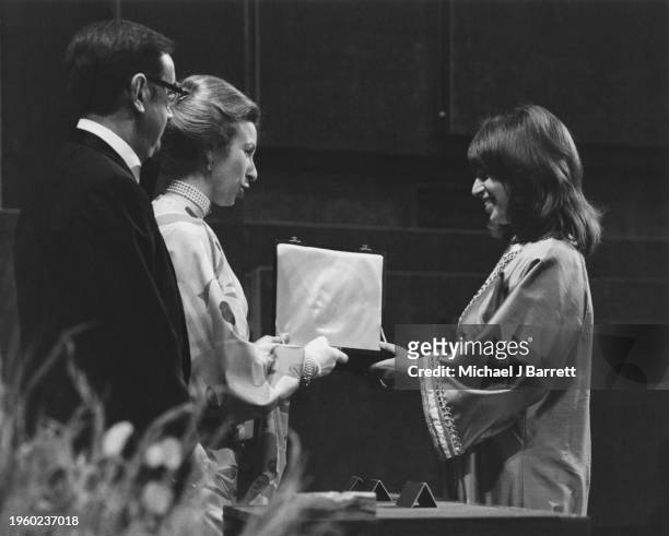Accepting the 1976 ANTHONY ASQUITH Award for TAXI DRIVER on behalf of her late husband BERNARD HERRMANN presented by OZZY MORRIS and HRH THE PRINCESS...