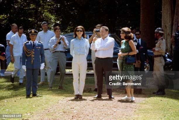 Former US First Lady Jacqueline Kennedy wearing a shirt and white trousers during a visit to the ruins of Angkor in Cambodia, November 3rd 1967. At...