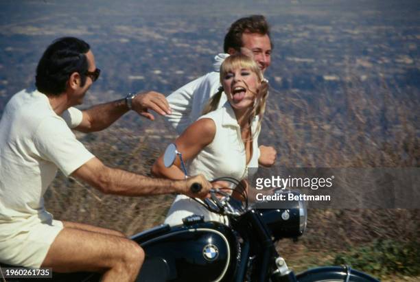 German actress Elke Sommer running along a roadside in Los Angeles, California, February 27th 1967. She is training for an upcoming role as an...