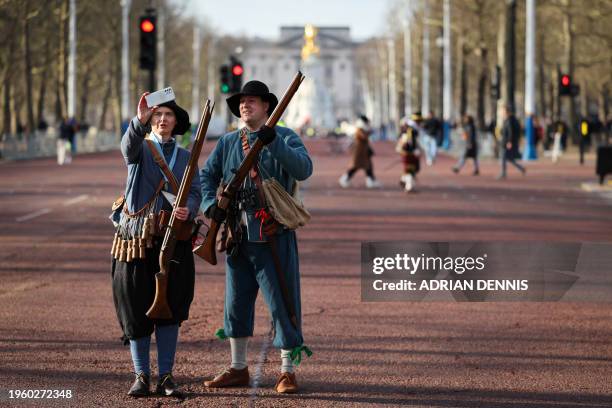 Members of the King's Army of the English Civil War Society take a selfie photograph with Buckingham Palace in the background before parading on The...