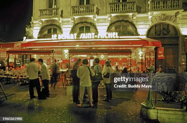 Nightlife in a small cafe and ice cream shop across from the Eiffel Tower along the Seine River in Paris, France, 2005. .