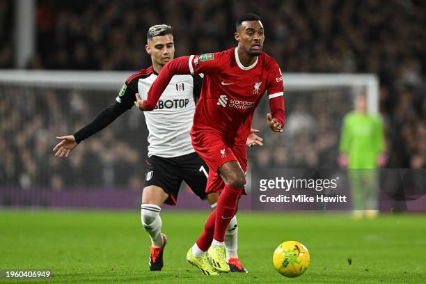 Ryan Gravenberch of Liverpool is challenged by Andreas Pereira of Fulham during the Carabao Cup Semi Final Second Leg match between Fulham and...