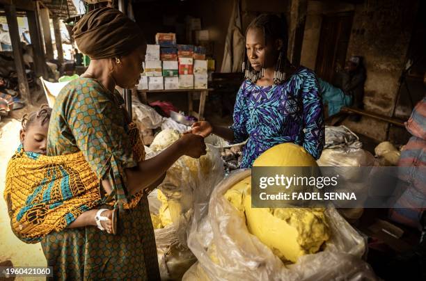 Vendor sells shea butter at an artisanal factory in Korhogo on January 28, 2024.