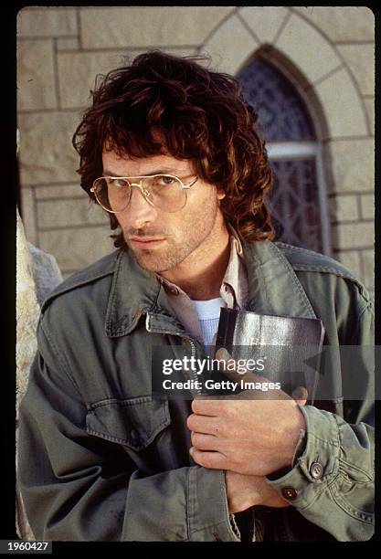 American actor Tim Daly holds a Bible close to his chest on the set of the TV movie 'In the line of fire: Ambush in Waco' on location, Tulsa,...