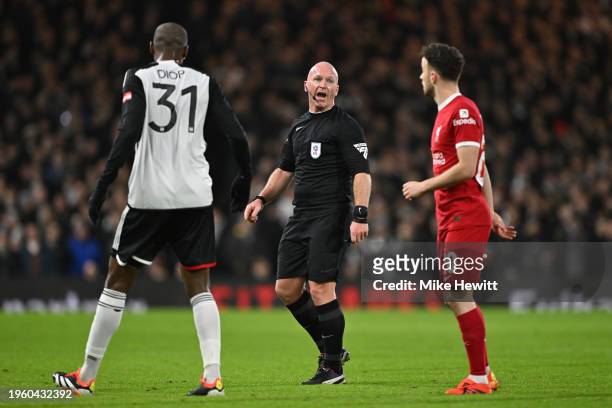 Referee Simon Hooper speaks to Issa Diop of Fulham and Diogo Jota of Liverpool during the Carabao Cup Semi Final Second Leg match between Fulham and...