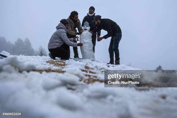 Tourists are making a snowman following fresh snowfall in North Kashmir District Baramulla, Jammu and Kashmir, India, on January 28, 2024. Various...