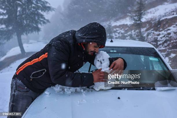Tourists are making a snowman following fresh snowfall in North Kashmir District Baramulla, Jammu and Kashmir, India, on January 28, 2024. Various...