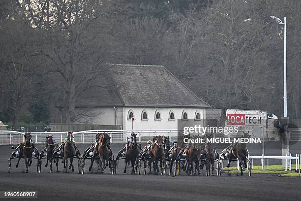 Jockeys drive their horses during the Grand Prix d'Amerique harness racing horse race at the Vincennes Hippodrome in Paris on January 28, 2024.