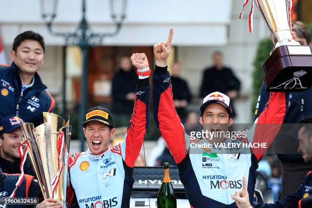 Belgian driver Thierry Neuville and Belgian co-driver Martijn Wydaeghe celebrate with their team on their Hyundai I20 N Rally1 Hybrid for Hyundai...