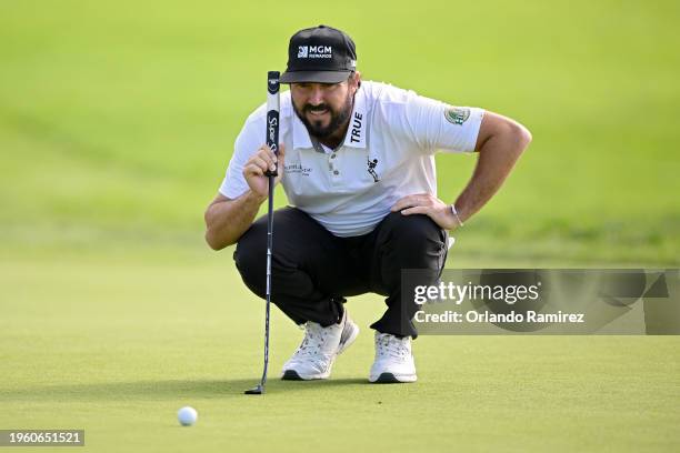 Mark Hubbard of the United States lines up a putt on the first green during the Farmers Insurance Open at Torrey Pines South Course on January 25,...