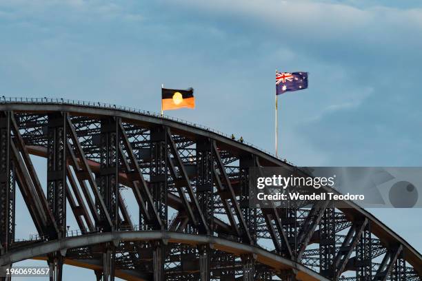 The Australian national and Aboriginal flags fly together atop the Sydney Harbour Bridge on 26th January 2024 in Sydney, Australia. Australia Day,...