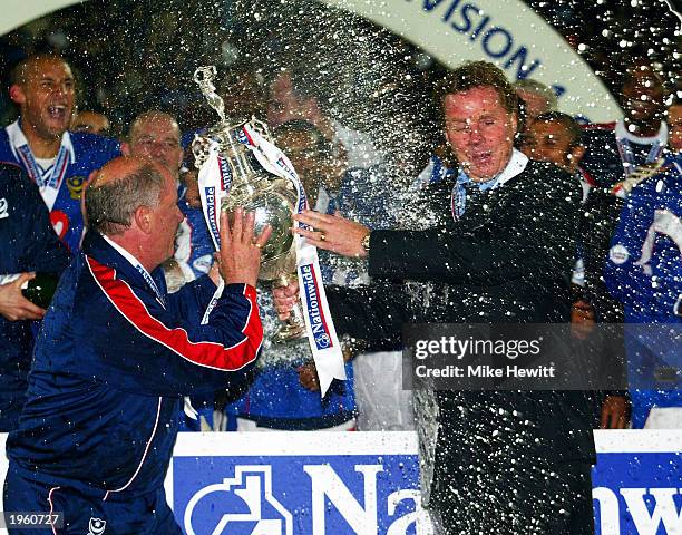 Portsmouth manager Harry Redknapp and his assistant Jim Smith are covered in champagne as they lift the league title up after the Nationwide League...