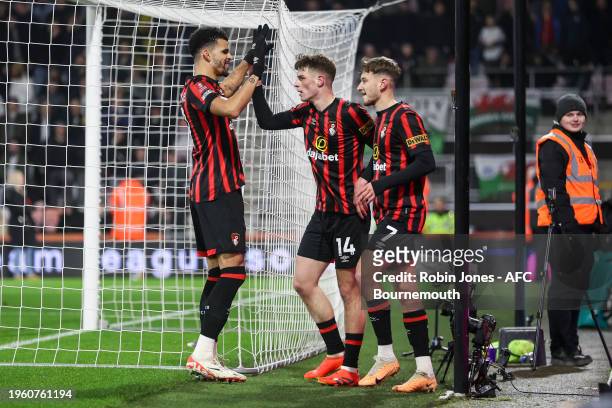 Alex Scott of Bournemouth is congratulated by team-mates Dominic Solanke and David Brooks after he scores a goal to make it 2-0 during the Emirates...