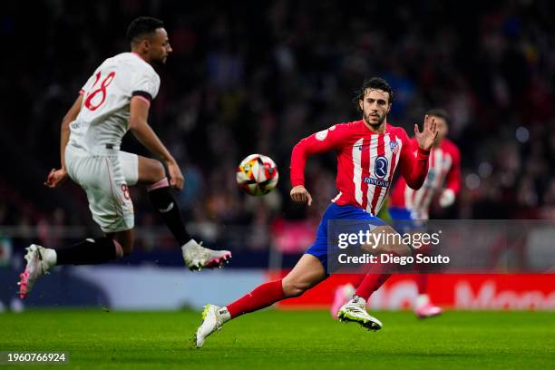 Mario Hermoso of Atletico de Madrid battles for the ball with Djibril Sow of Sevilla FC during Copa del Rey Round of quarter final between Atletico...