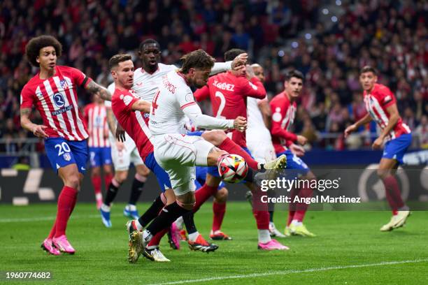 Sergio Ramos of Sevilla FC competes for the ball with Saul Niguez of Atletico de Madrid during the Copa del Rey Quarter Final match between Atletico...