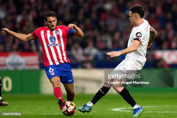 Koke of Atletico de Madrid battles for possession with Lucas Ocampos of Sevilla FC during the Copa del Rey Quarter Final match between Atletico de...