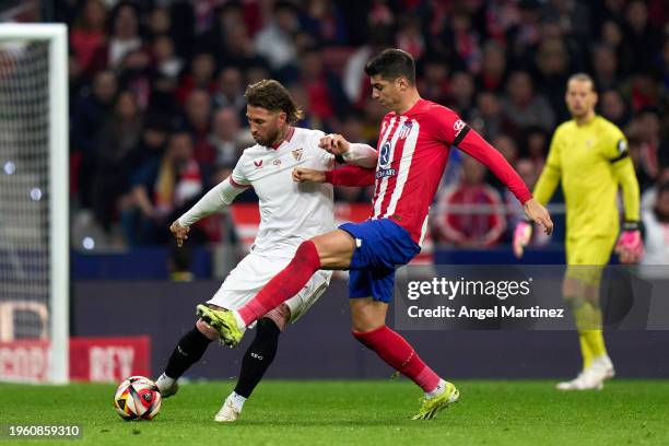 Sergio Ramos of Sevilla FC is challenged by Alvaro Morata of Atletico de Madrid during the Copa del Rey Quarter Final match between Atletico de...