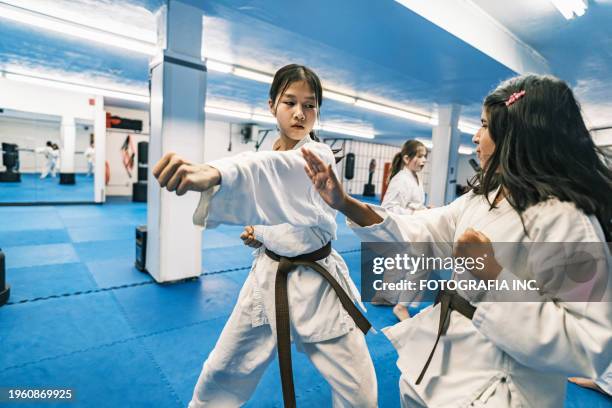 young karate fighters in karate school - vechtsport stockfoto's en -beelden