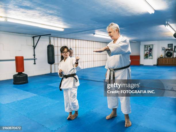 sensei teaching young karate fighters in karate school - teach to fight stock pictures, royalty-free photos & images