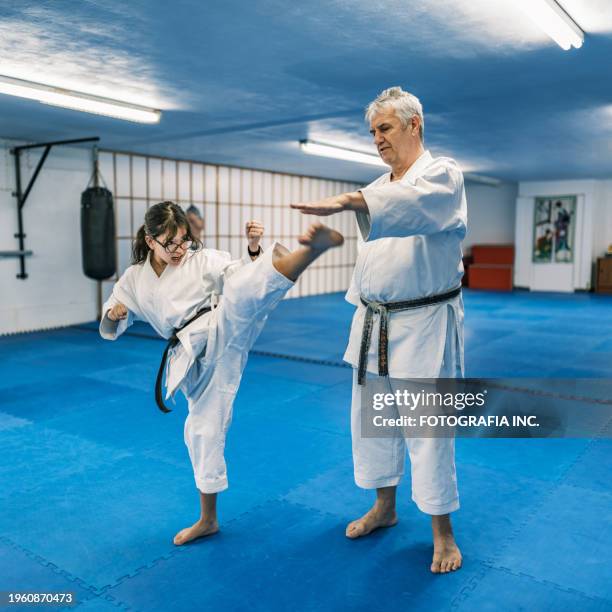 sensei teaching young karate fighters in karate school - gidräkt bildbanksfoton och bilder