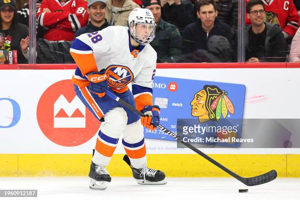 Alexander Romanov of the New York Islanders skates with the puck against the Chicago Blackhawks during the first period at the United Center on...