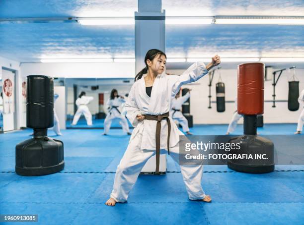 young karate fighters in karate school - sparring stock-fotos und bilder