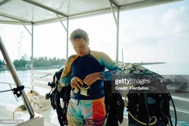 red-haired woman in diving clothes - high diving platform stock pictures, royalty-free photos & images