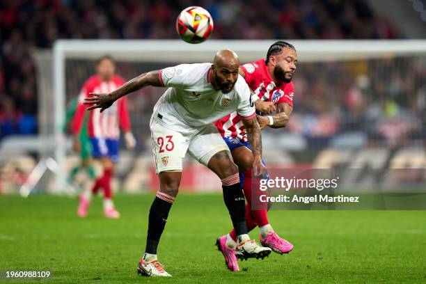 Marcao do Nascimento of Sevilla FC battles for possession with Memphis Depay of Atletico de Madrid during the Copa del Rey Quarter Final match...