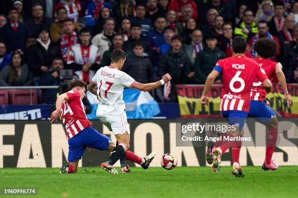 Pablo Barrios of Atletico de Madrid competes for the ball with Erik Lamela of Sevilla FC during the Copa del Rey Quarter Final match between Atletico...