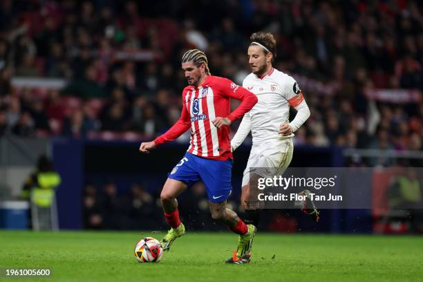 Rodrigo De Paul of Atletico de Madrid is put under pressure by Ivan Rakitic of Sevilla FC during the Spanish Copa del Rey Quarter Final match between...