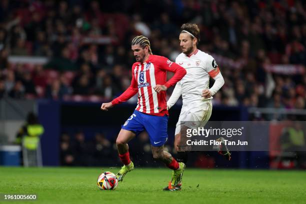 Rodrigo De Paul of Atletico de Madrid is put under pressure by Ivan Rakitic of Sevilla FC during the Spanish Copa del Rey Quarter Final match between...
