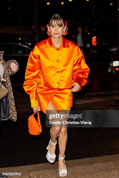 Actress Nina Dobrev is seen wearing orange jacket, skirt, bag outside Patou during the Haute Couture Spring/ Summer 2024 as part of Paris Fashion...