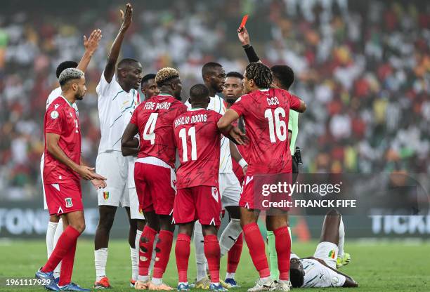 Somali referee Omar Abdulkadir Artan shows a red card to Equatorial Guinea's midfielder Fede Bikoro during the Africa Cup of Nations 2024 round of 16...