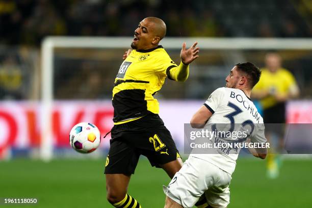 Dortmund's Dutch forward Donyell Malen and Bochum's German defender Maximilian Wittek vie for the ball during the German first division Bundesliga...