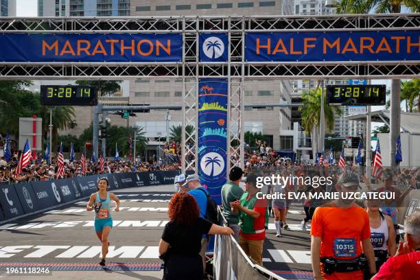 Runners arrive at the finish line after completing the Life Time Miami Marathon and Half in Miami, Florida, on January 29, 2023. The marathon began...