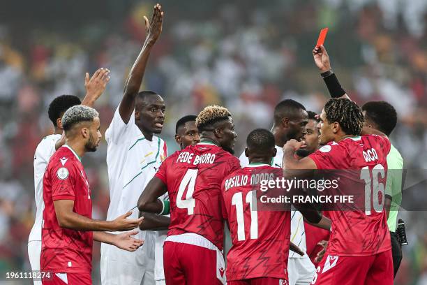 Somali referee Omar Abdulkadir Artan shows a red card to Equatorial Guinea's midfielder Fede Bikoro during the Africa Cup of Nations 2024 round of 16...