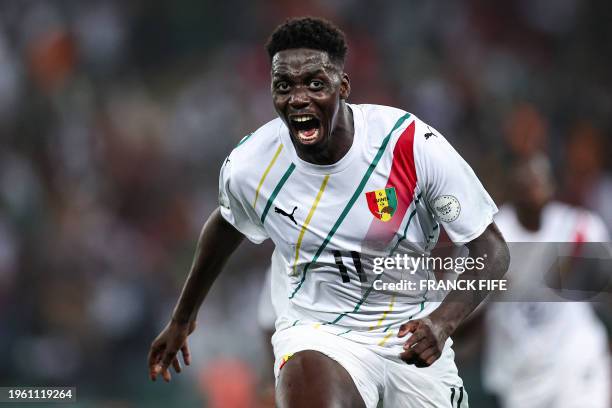 Guinea's midfielder Mohamed Bayo celebrates scoring his team's first goal during the Africa Cup of Nations 2024 round of 16 football match between...