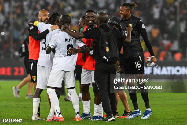 Guinea's players celebrate after the victory at the end of the Africa Cup of Nations 2024 round of 16 football match between Equatorial Guinea and...