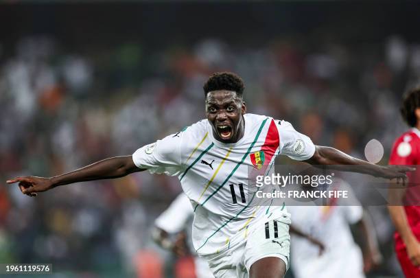 Guinea's midfielder Mohamed Bayo celebrates scoring his team's first goal during the Africa Cup of Nations 2024 round of 16 football match between...